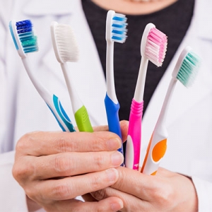 Which bristles of toothbrush should people who have corroded cavity or recessions use?